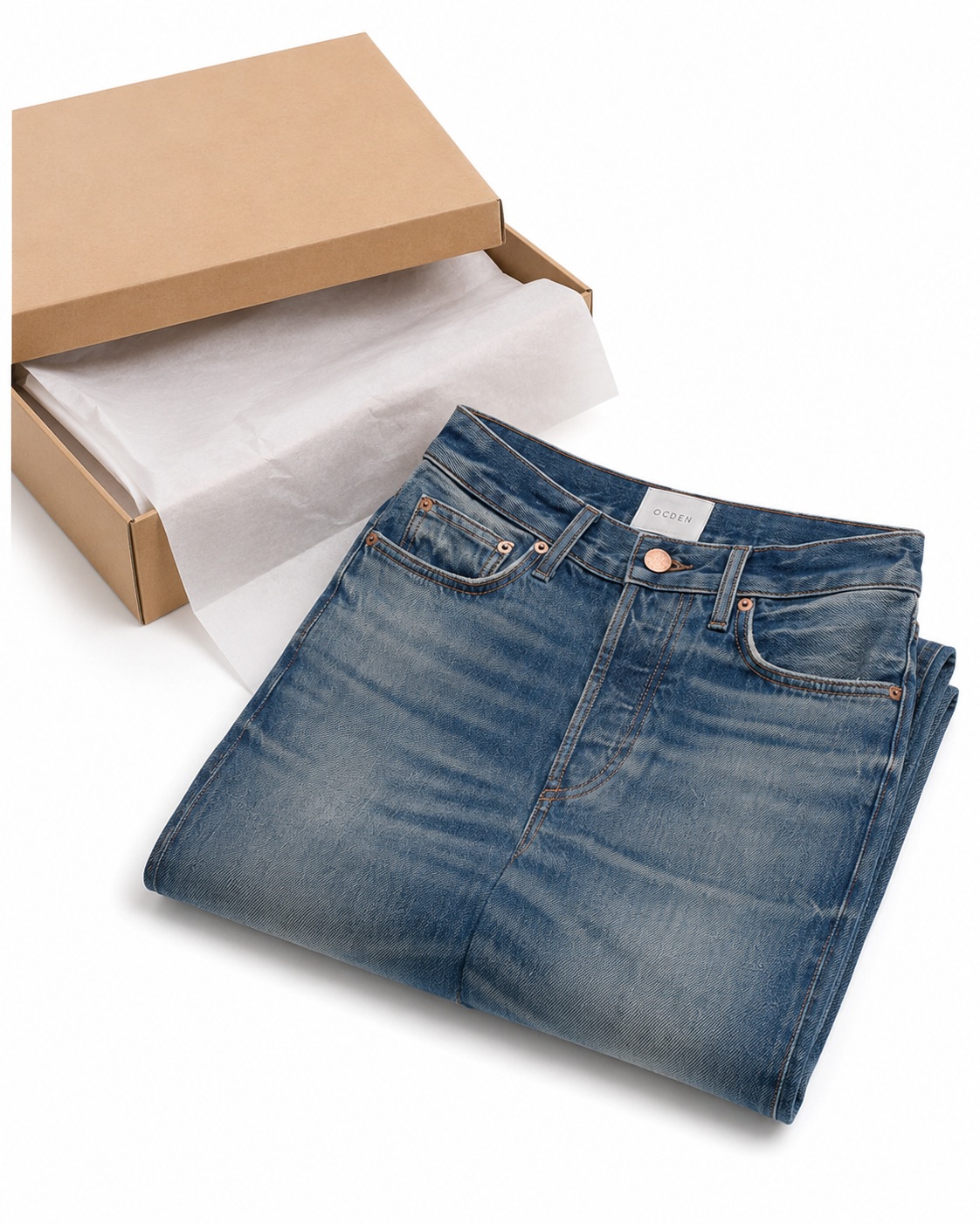 Jeans folded beside simple packaging for an e-commerce presentation.